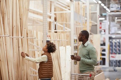 Man and son looking at wood and lumber.