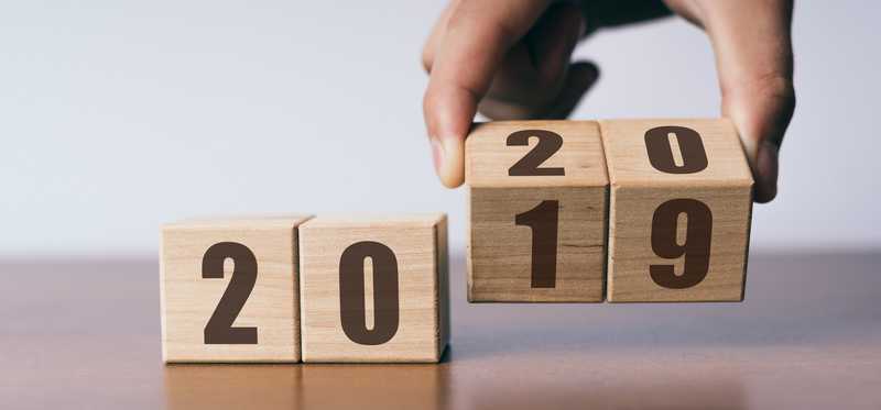 Wood blocks forming 2019 with hand turning to 2020