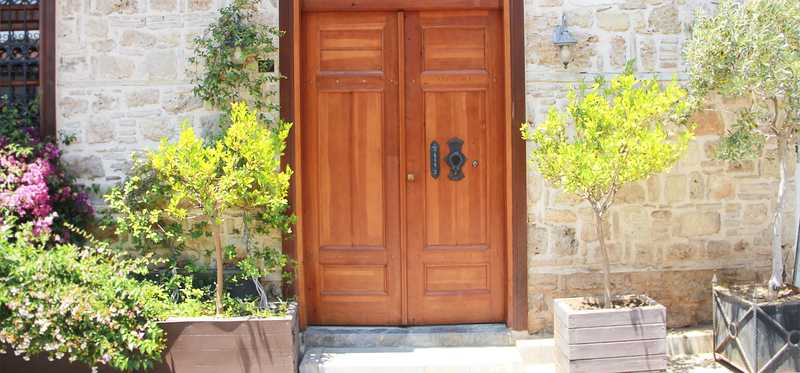 Wooden front door on stone house.