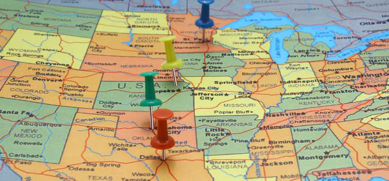 A map of the United States with a few pushpins in it.