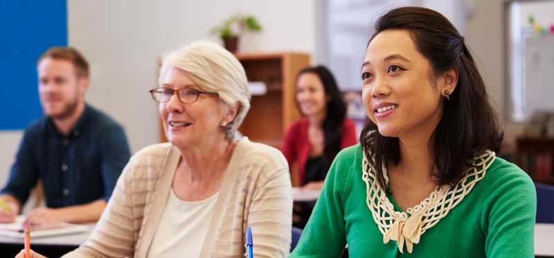 Two people share a table in an adult education class.