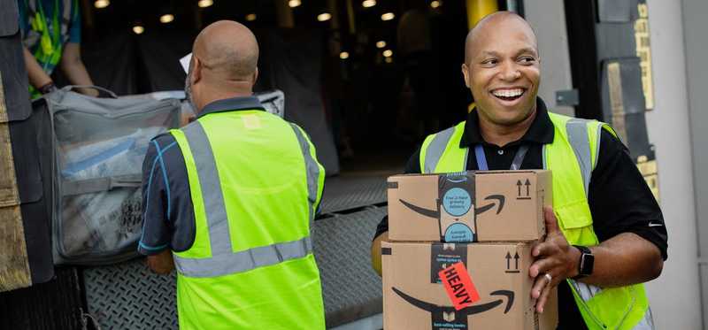 Amazon employees unloading a truck
