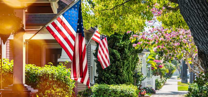 American flags hanging from front porches