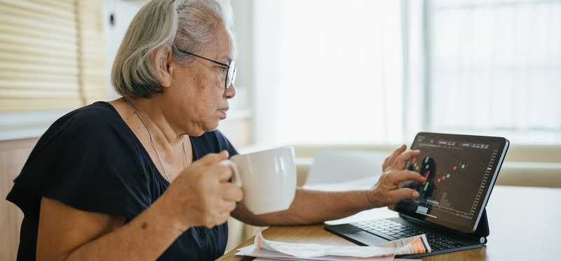 Person calculating expenses and bills at home.