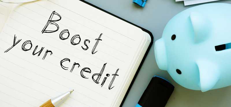 Note that says Boost Your Credit next to a piggy bank.
