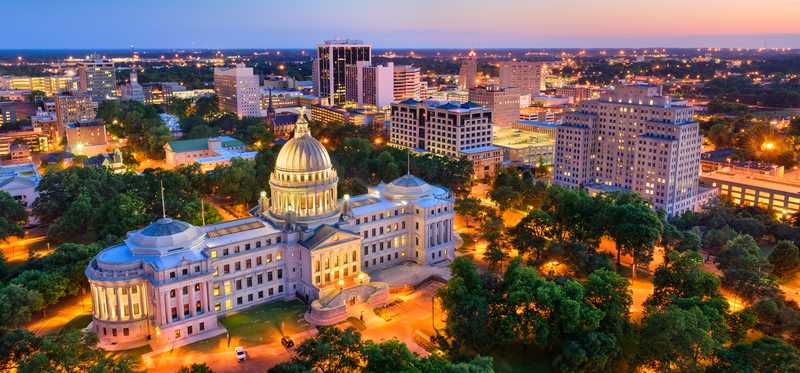 Twilight-lit aerial of Jackson, Mississippi, downtown and capitol.