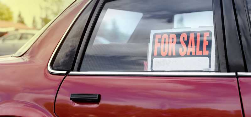 Car with a for sale sign in the window.