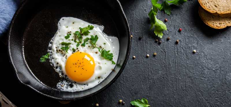 Fried eggs in a cast iron skillet.