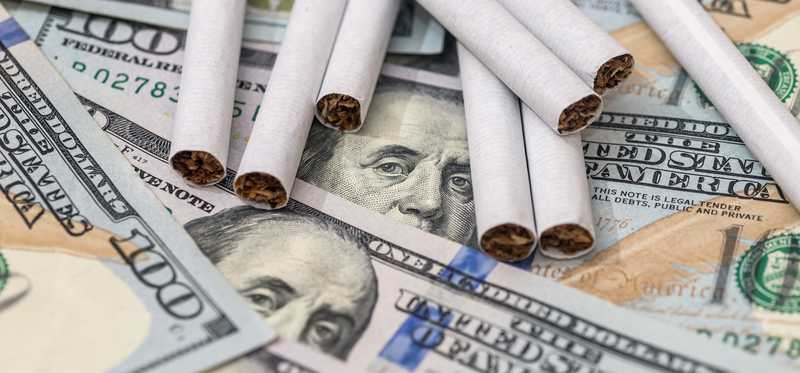 Cigarettes on hundred dollar bills