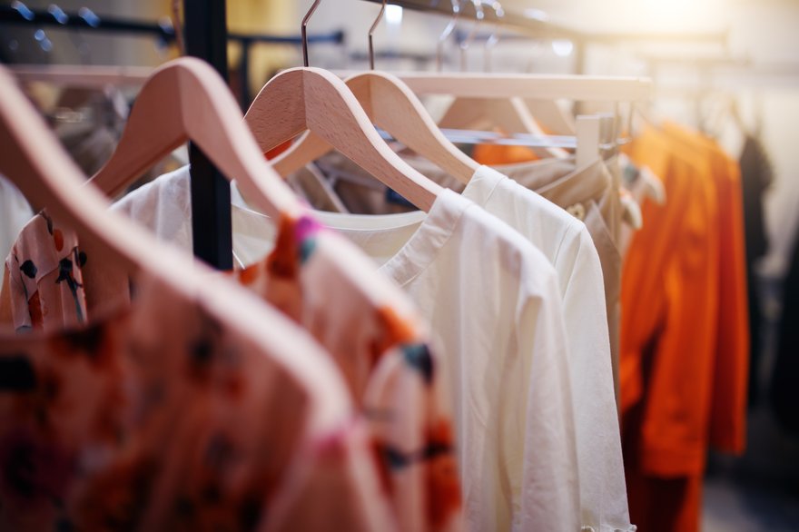 clothing hanging on a rack in a store