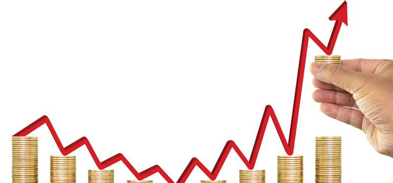Stacks of coins with rising red arrow over them