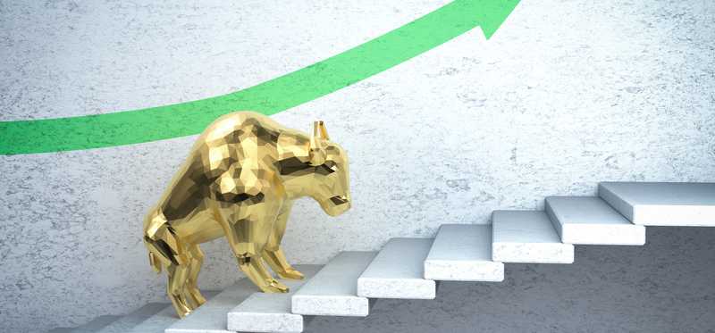Gold bull figure walking up steps in illustration of bull market