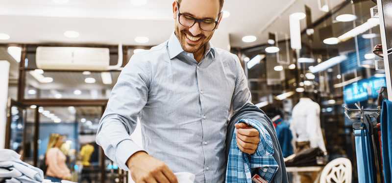 Person shopping in a clothing store.