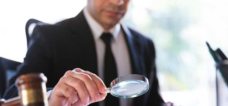 Person looking through a magnifying glass.
