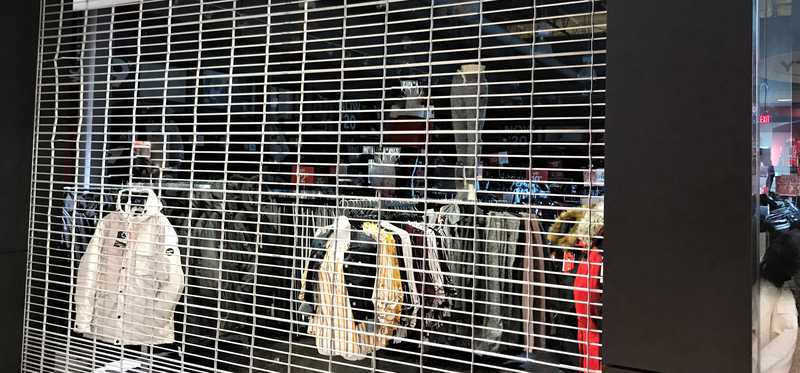 Closed retail store with its metal gate down