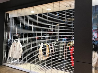 Closed retail store with its metal gate down