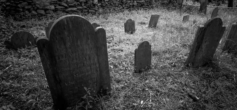 A black and white photo of a graveyard.