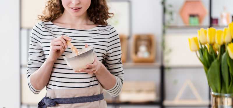 Person stirring mixture in bowl.