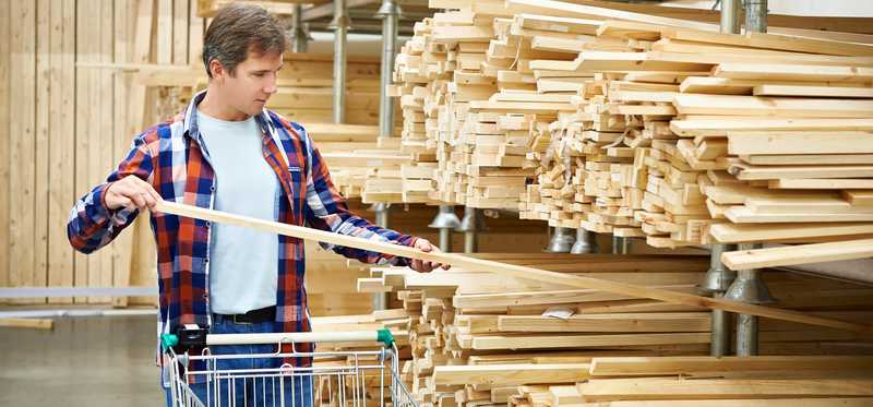 A person shops for lumber.