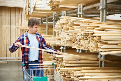 A person shops for lumber.