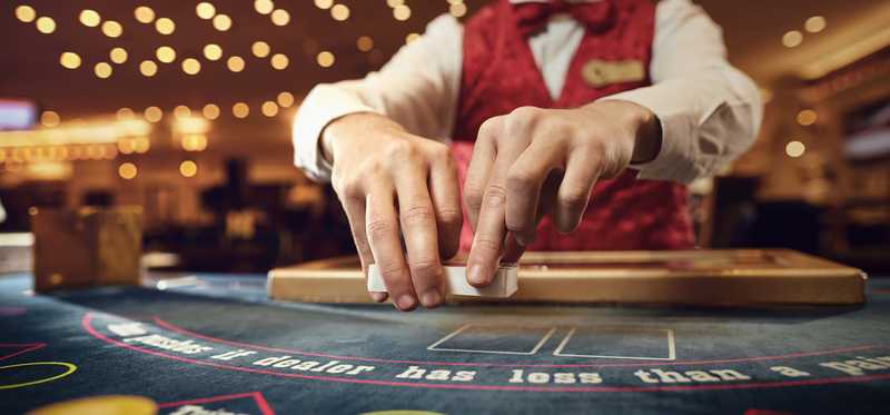 A dealer at a casino gaming table.
