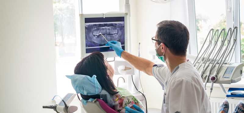A dentist works on a patient.