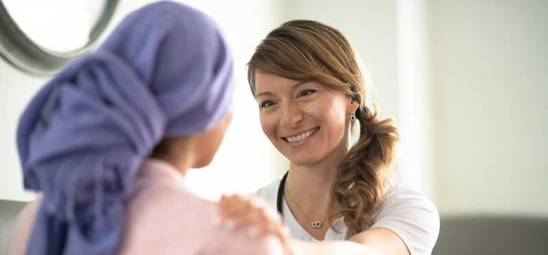 A medical professional assures a patient.