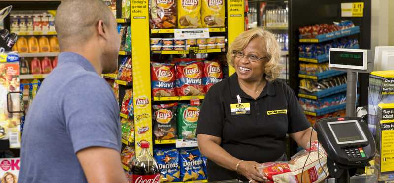 Dollar General cashier checking out a customer.