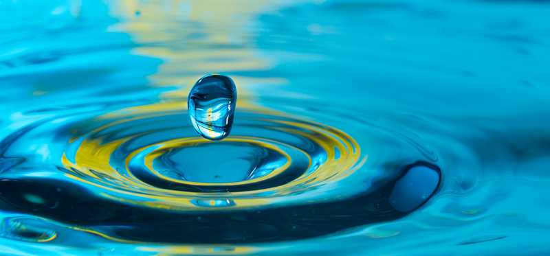 A water droplet landing in a puddle.