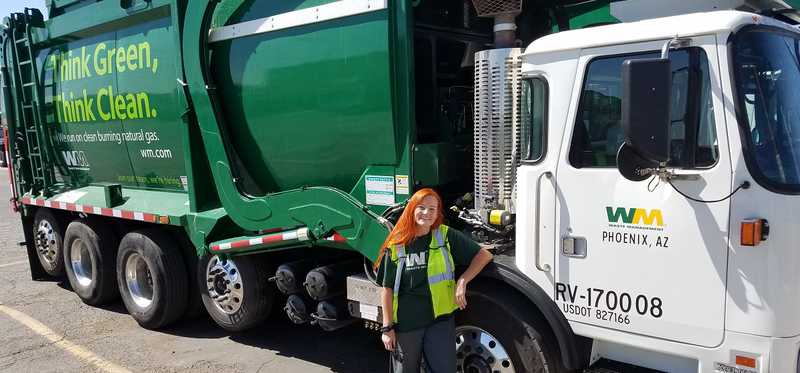 driver standing next to Waste Management truck