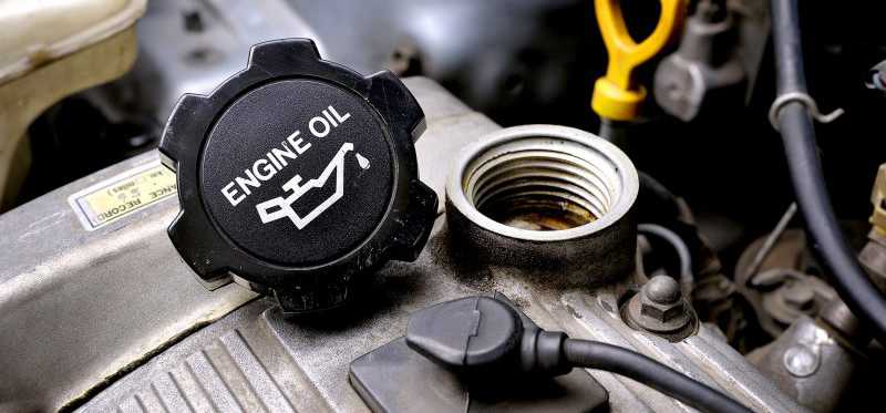 An engine oil cap sitting on an engine block.