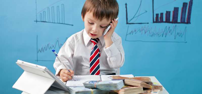 A child dressed up in business attire representing a financial manager.