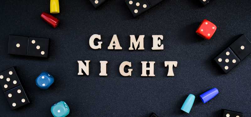 Dominoes, dice, and Game Night spelled out.