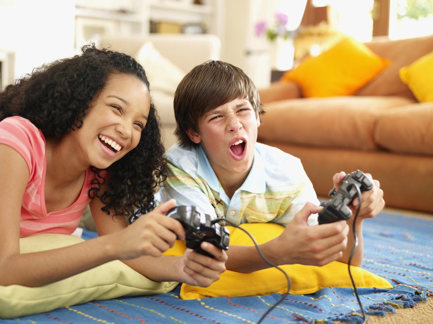 Two kids play a video game together.