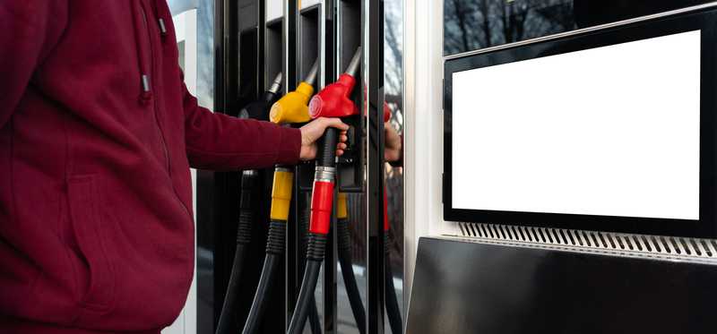 A person at gas pumps.