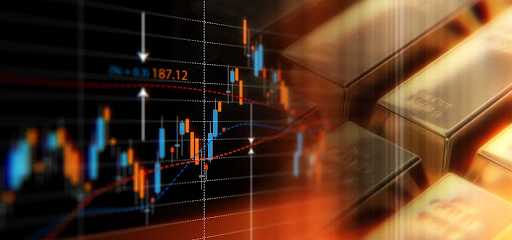Gold bars next to an investment chart.