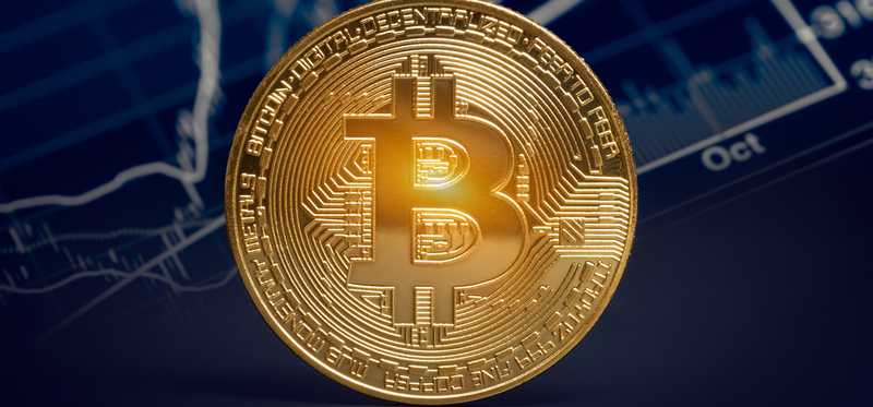 Gold coin with Bitcoin symbol on it.