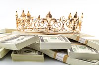 Golden crown resting on piles of cash.