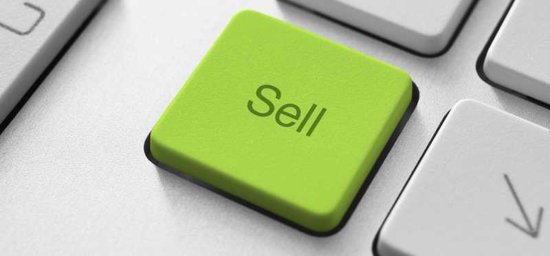 A keyboard with a green button that says Sell.