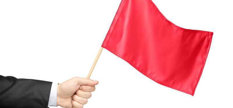 Hand holding red flag