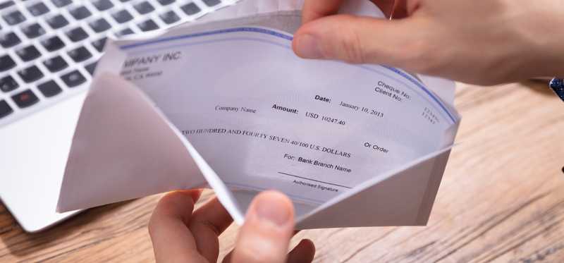 Hand opening check in envelope