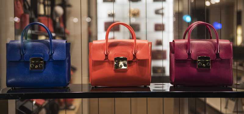Three handbags are lined up.
