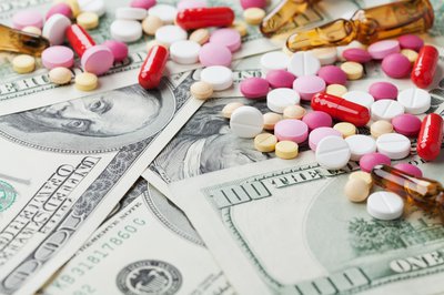 Pills scattered on top of money.