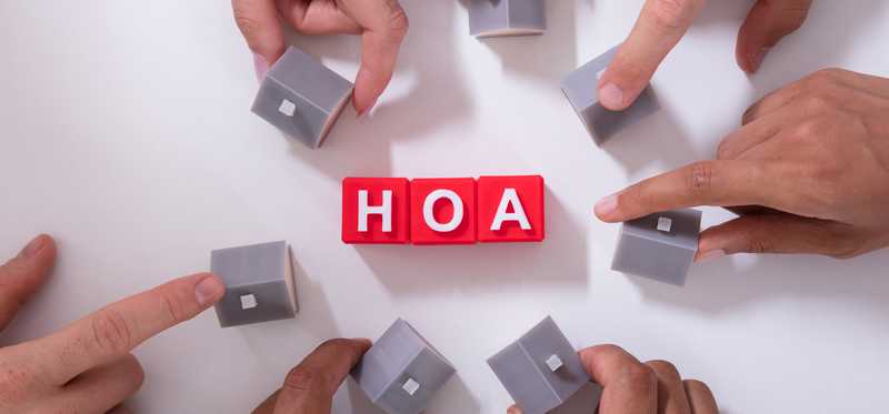 The letters H O A surrounded by small houses.