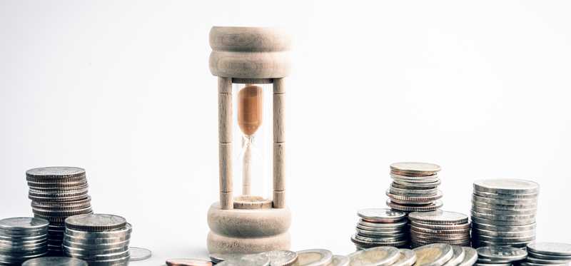 Hourglass surrounded by coins