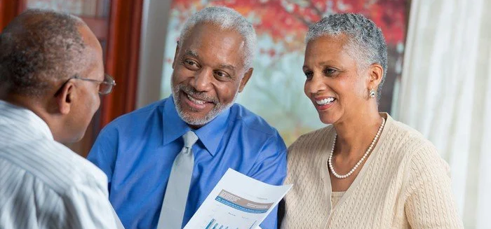 People discussing retirement savings with a financial planner.