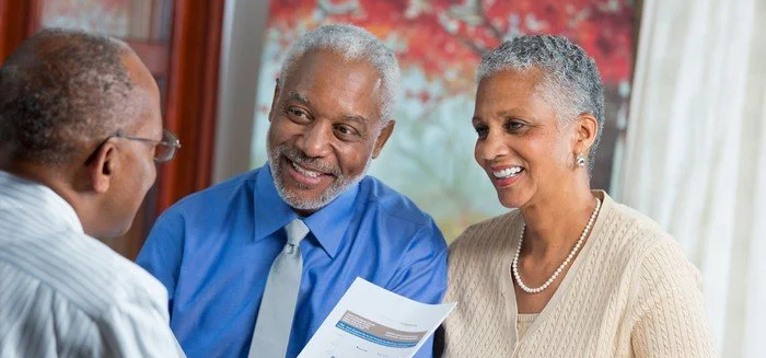 People discussing retirement savings with a financial planner.