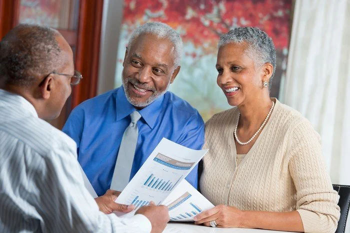 People discussing retirement savings with a financial planner.