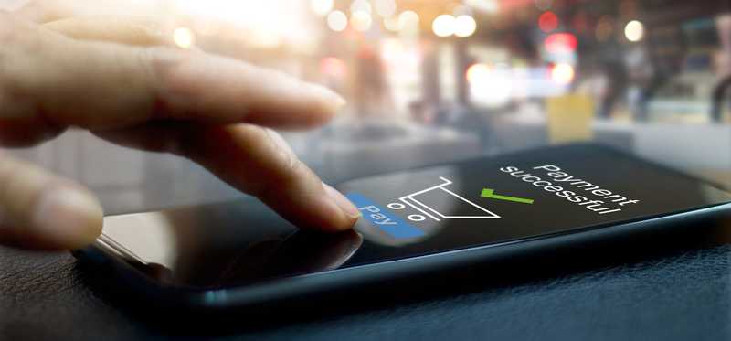 Person uses a smartphone to make a purchase.