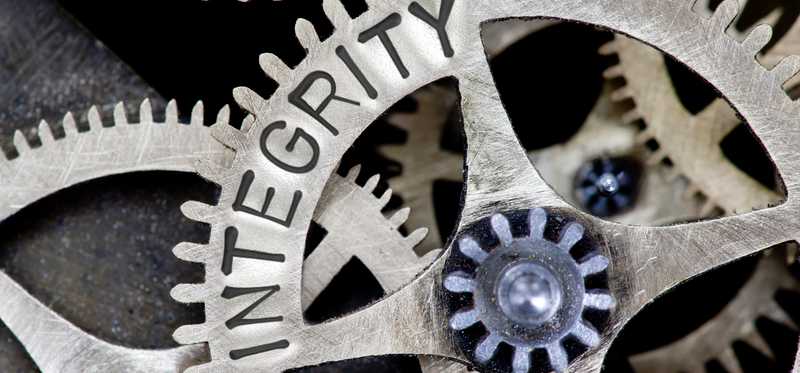 Gears have the word integrity written on them.